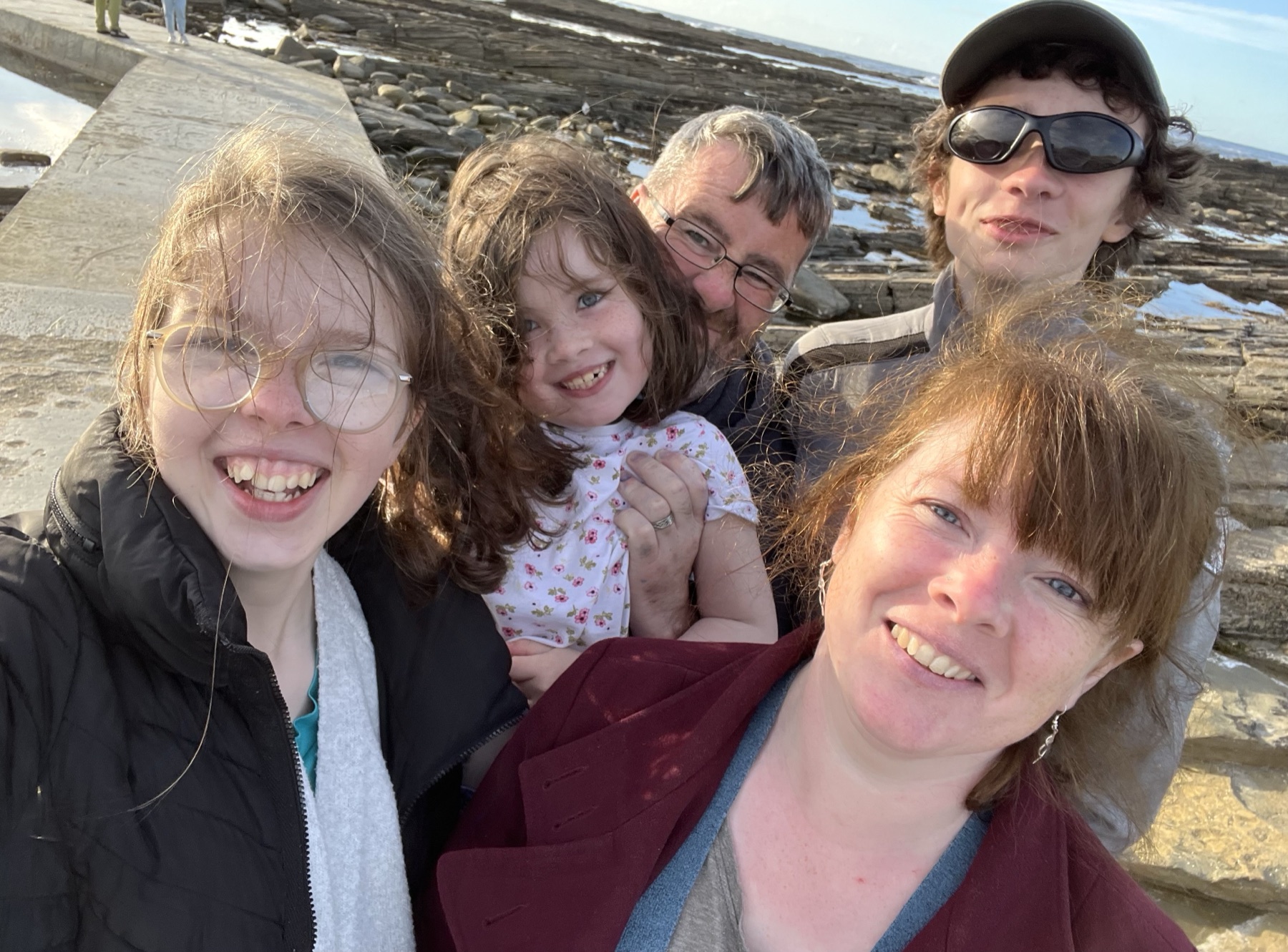 Claire Kirkpatrick with her family on the shore in Orkney